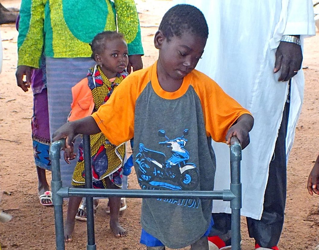 Yaya was not able to walk without assistance until a missionary build him a walker out of PVC pipe.