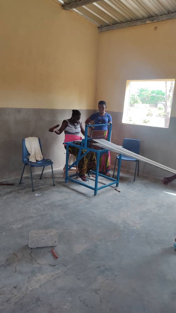 Girl weaving Fabric on a floor loom